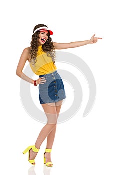 Vibrant Young Woman In Jeans Mini Skirt And High Heels Is Pointing And Laughing