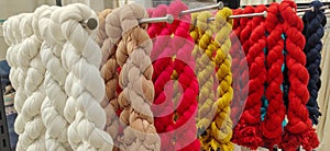 Vibrantly colored and textured yarns hanging