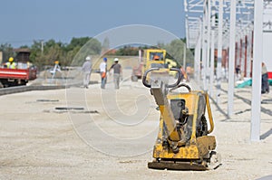Vibrating plate compactor at construction site