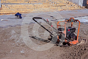 Vibrating plate compactor machine at a construction site. Equipment for soil thrombosis. Compaction work on sand, earth or asphalt