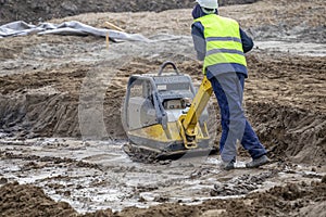 Vibration plate compactor, compacting soil