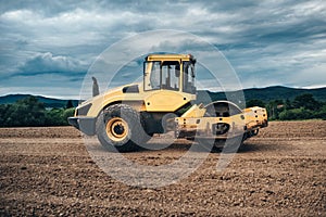 vibration roller compactor working on highway ground construction site