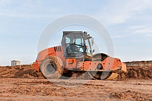 Vibration single-cylinder road roller leveling the ground for the foundation