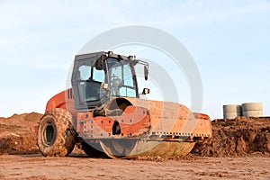 Vibration single-cylinder road roller leveling the ground for the foundation. Soil Compactor for laying asphalt