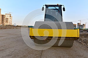 Vibration single-cylinder road roller leveling the ground for the foundation. Soil Compactor for laying asphalt on road at
