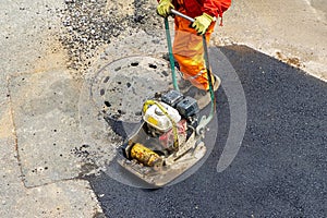 Vibratory plate compactor paving work