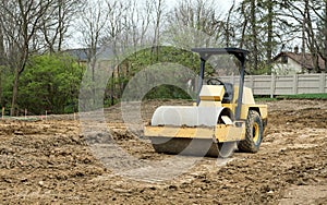 Vibratory Roller Compacting Soil at Construction Site