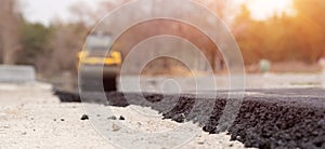 The vibratory roller levels the asphalt pavement