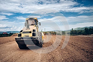 Vibratory Soil Compactor during highway building. Industrial roadworks with heavy-duty machinery photo