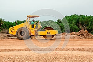 Vibratory soil compactor working on highway construction site. Tandem vibration roller compactor working on highway ground constru