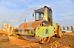 Vibro Roller Soil Compactor leveling ground at construction site. Vibration single-cylinder road roller on construction road. Road