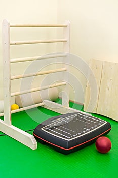 vibroplatform and ball on green mat in photo
