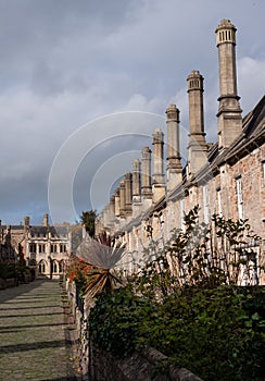 Vicars` Close, in Wells, Somerset UK. Street of medieval terraced houses with iconic chimneys behind Wells Cathedral.