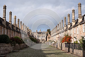 Vicars` Close, in Wells, Somerset UK. Street of medieval terraced houses with iconic chimneys behind Wells Cathedral.