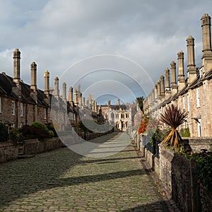 Vicars` Close, in Wells, Somerset UK. Street of medieval terraced houses with iconic chimneys behind Wells Cathedral.