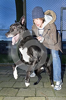 Vicious dog leaping away from his owner photo