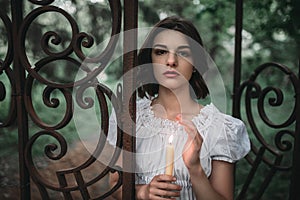 Victim at the gates of old cemetery in forest