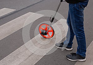 Victim of a traffic accident on pedestrian crossing - distance measuring wheel device.