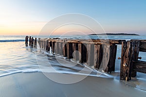 The Victor Harbor erosion groyne with a long exposure and granite island in background and pastel skies in South Australia on