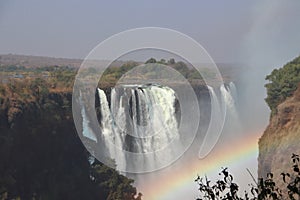Victoria falls with rainbow during dry season on holiday with sambesi river in zambia.