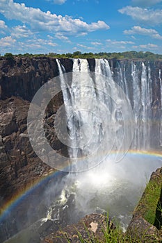 Victoria Falls with rainbow on Zambezi River, view from Zimbabwe, Africa