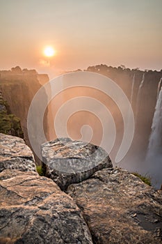 Victoria Falls sunset from Zambia side, rocks in the foreground