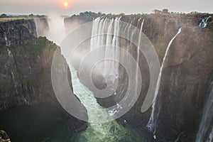 Victoria Falls sunset, Zambia side with zambezi river, red sun