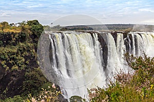 Victoria Falls, a waterfall in southern Africa at the Zambezi River at the border between Zambia and Zimbabwe. Milky water