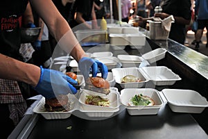 Fast food preparation of hamburgers in an outdoor market in London England