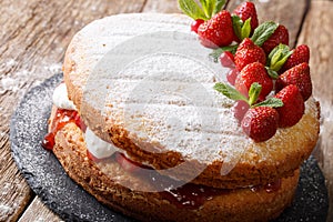 Victoria sandwich cake, decorated with strawberries, cranberries photo