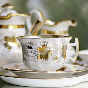 Victorian antique porcelain coffee cup in gold and white