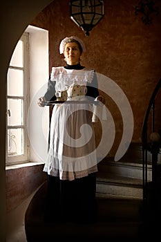 Victorian chambermaid serving tea