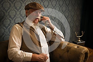 Victorian gentleman with antique phone