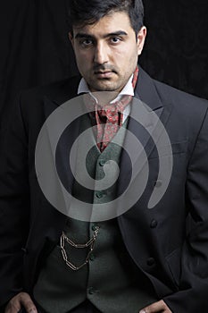 Victorian gentleman posing in a room resembling a study