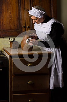 Victorian kitchen maid cleaning