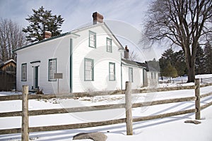 Victorian style house exterior with wooden  post and rail fence in winter