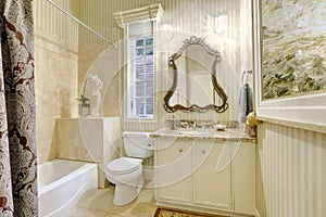 Victorian style master bathroom in warm creamy tones.