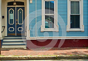 Victorian windows, door, blue walls and red brick sidewalk