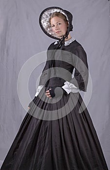 Victorian woman in black bodice. bonnet and skirt