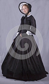 Victorian woman in black bodice. bonnet and skirt
