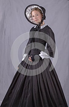 Victorian woman in black bodice. bonnet and skirt photo
