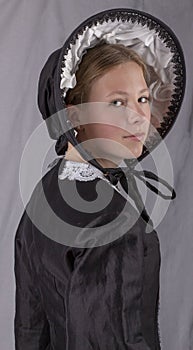 Victorian woman in a black bodice and bonnet photo