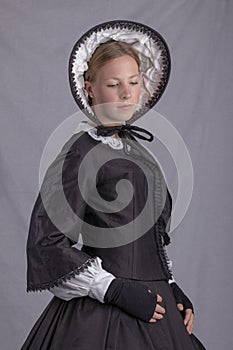 Victorian woman in a black bodice and bonnet photo
