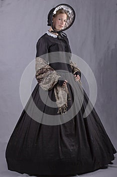 Victorian woman in a black bodice, shawl and bonnet photo