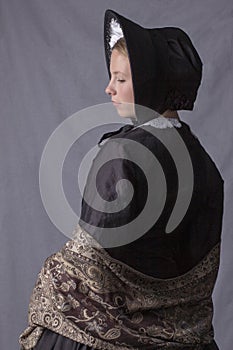 Victorian woman in a black bodice, shawl and bonnet photo