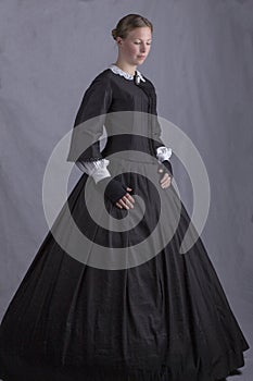 Victorian woman in a black bodice and skirt photo