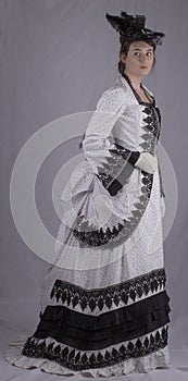 Victorian woman in black and white bustle dress