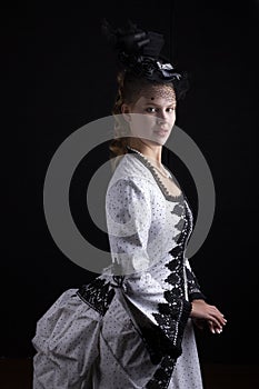 Victorian woman in black and white bustle dress and hat