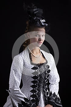 Victorian woman in black and white bustle dress and hat