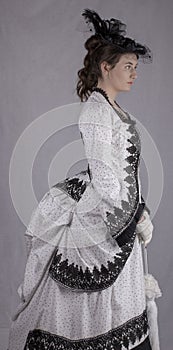 Victorian woman in black and white bustle dress